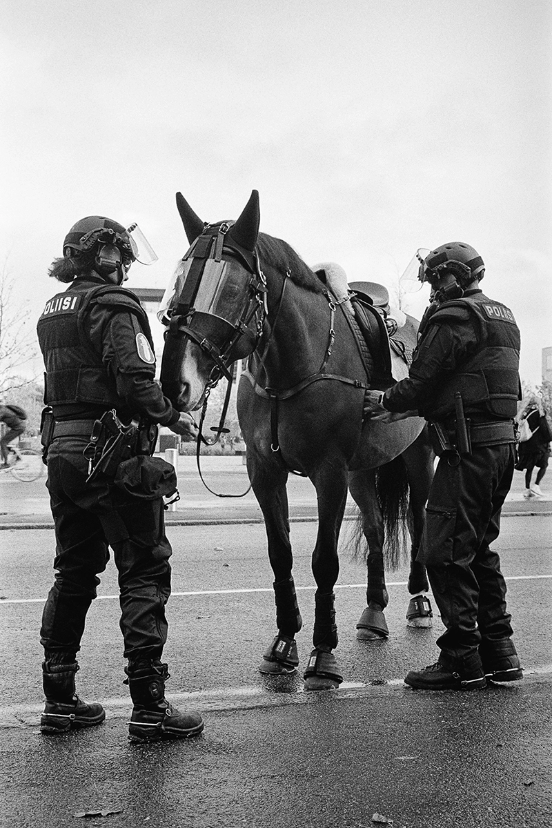 Black and white anlaog photograph of a woman eating a chocolate bar