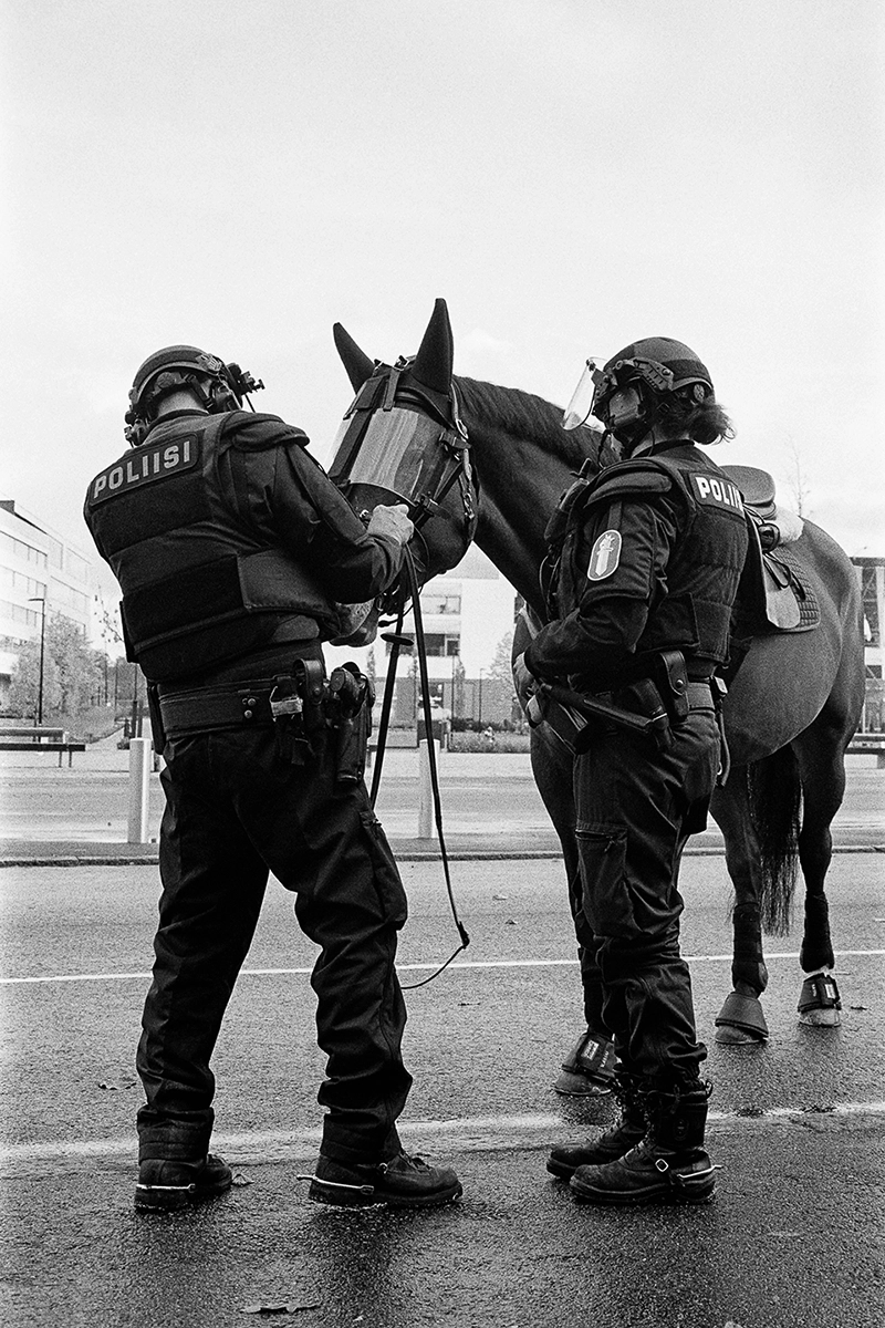 Black and white anlaog photograph of a woman eating a chocolate bar