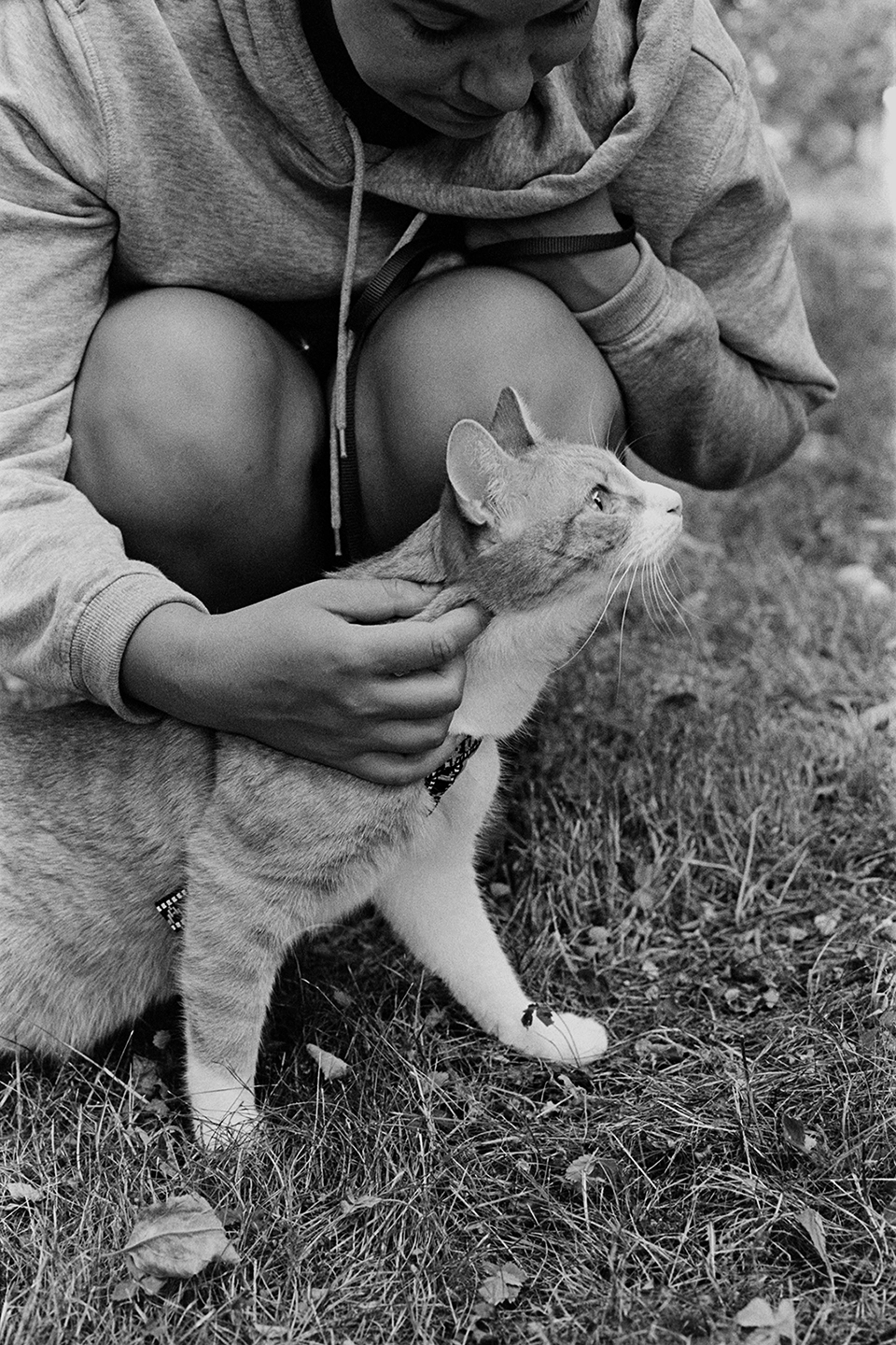 Black and white anlaog photograph of a woman with a cat