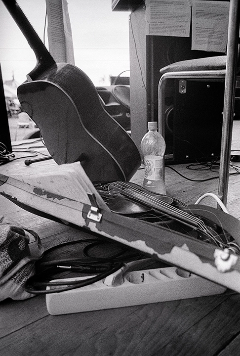 Black and white anlaog photograph of musical instruments on a performance stage