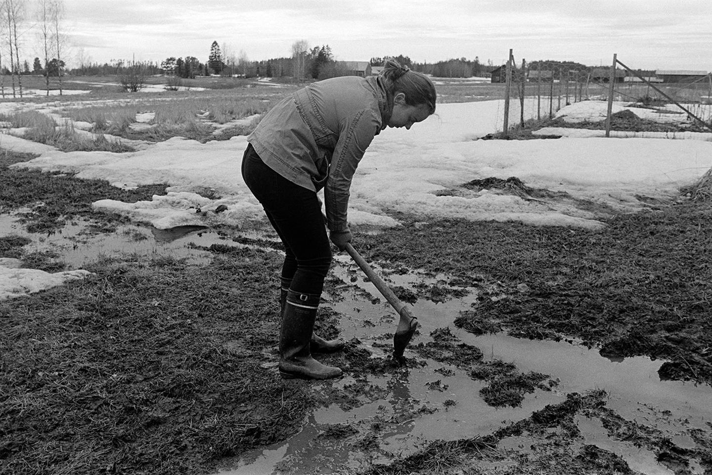 Black and white anlaog photograph of a woman working in a field